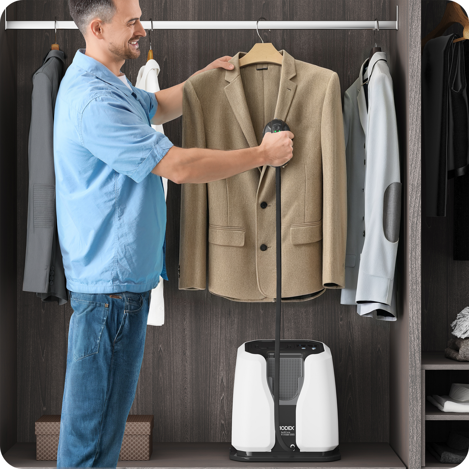 Man using a handheld steamer on a beige blazer in a wardrobe.