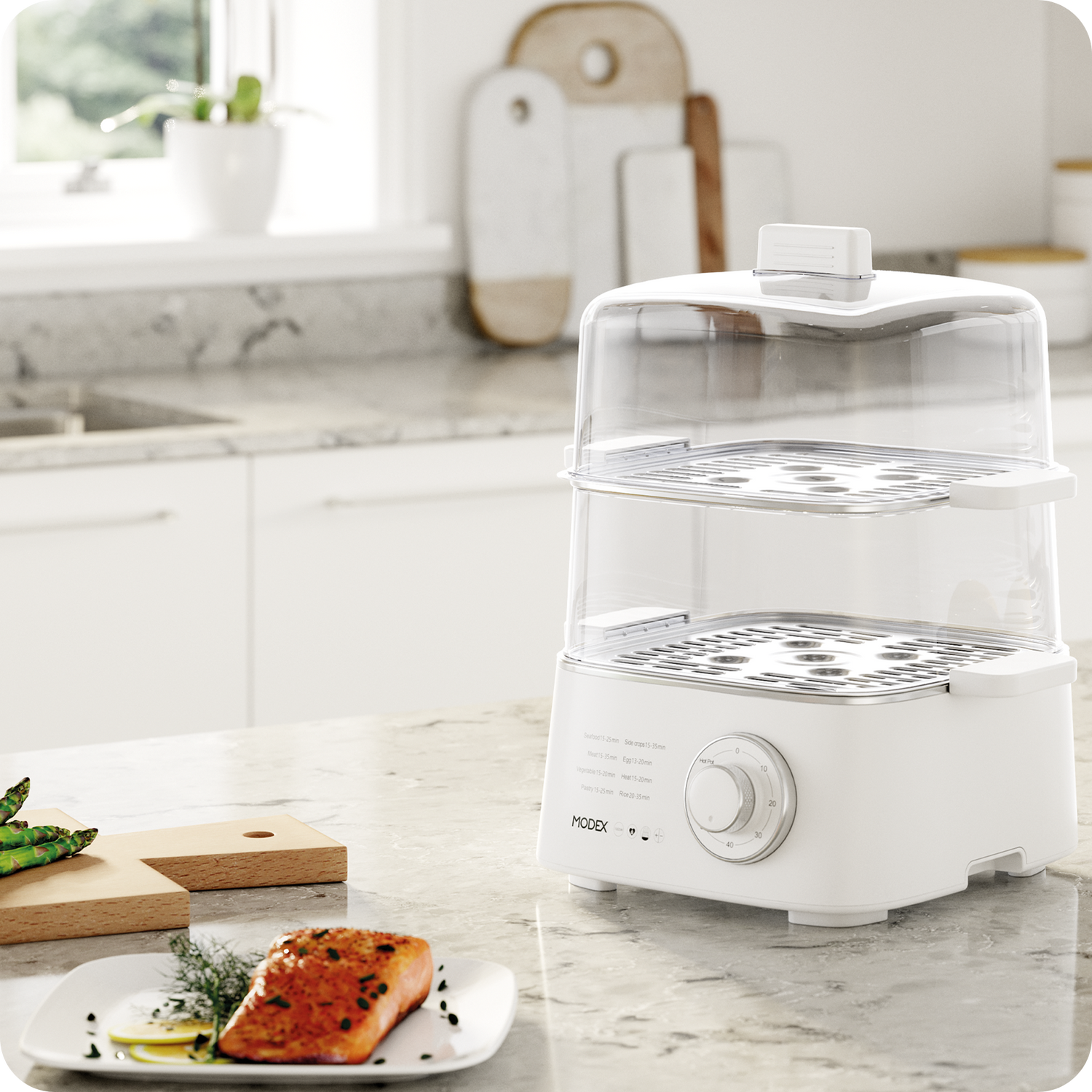 MODEX food steamer with two transparent tiers placed on a bright kitchen counter.