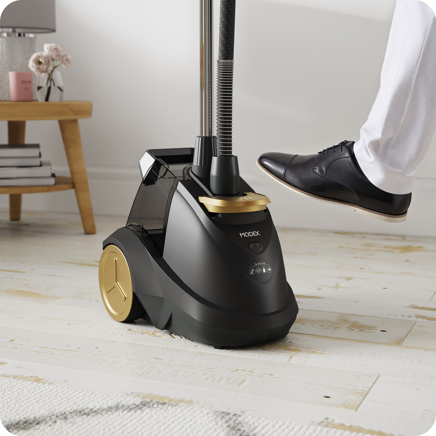 Black and gold shoe steamer on a wooden floor with a person's foot stepping onto it.