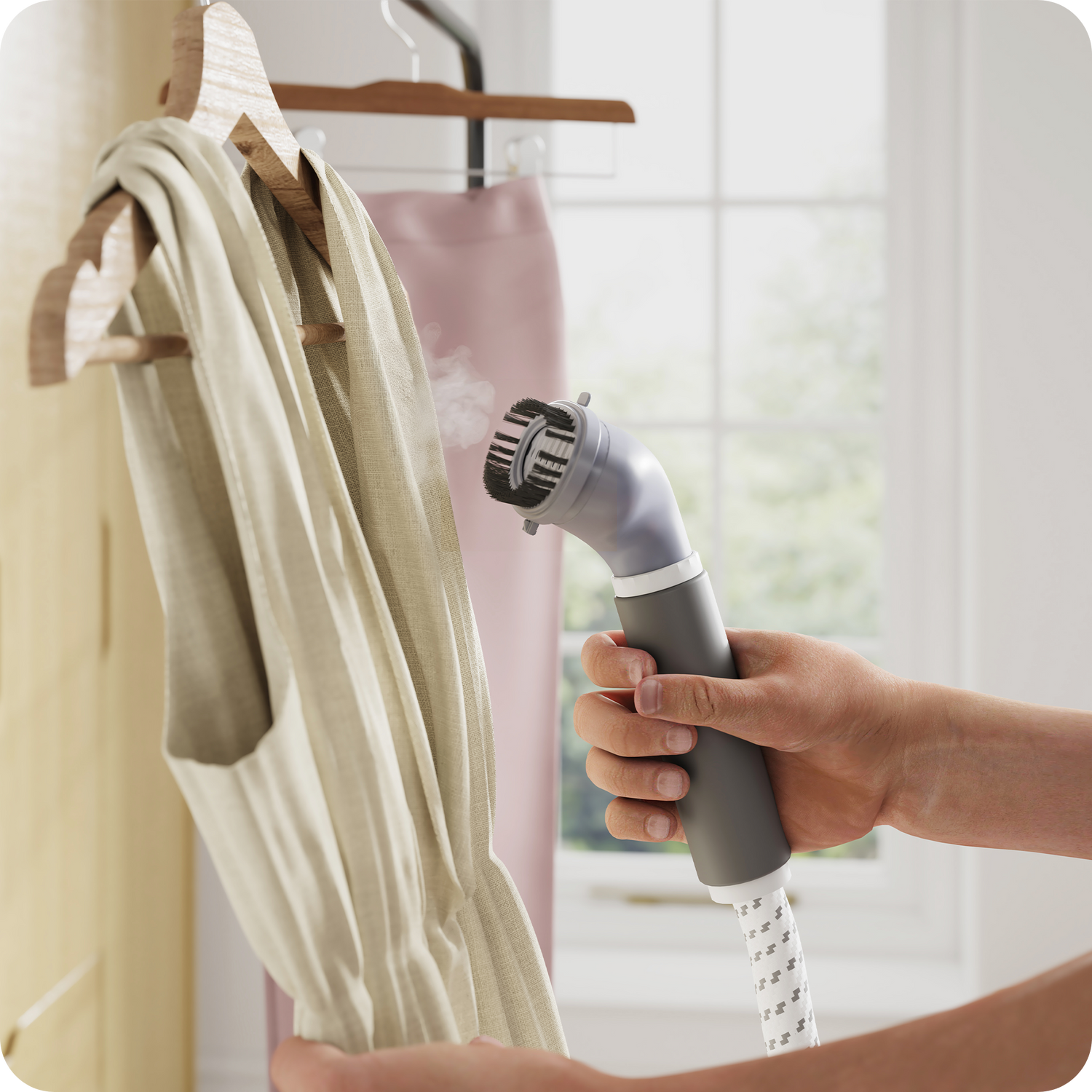 Garment steamer holding a hanging blouse for vertical steaming.
