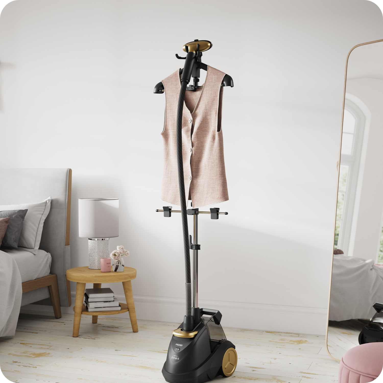 Garment steamer holding a hanging blouse for vertical steaming.
